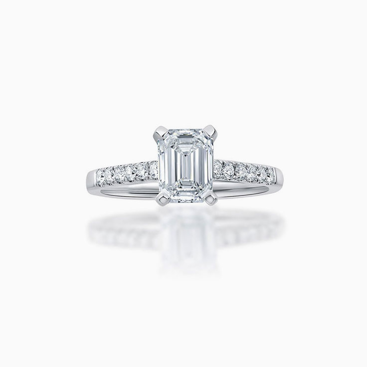 Emerald cut diamond engagement ring on a pave band